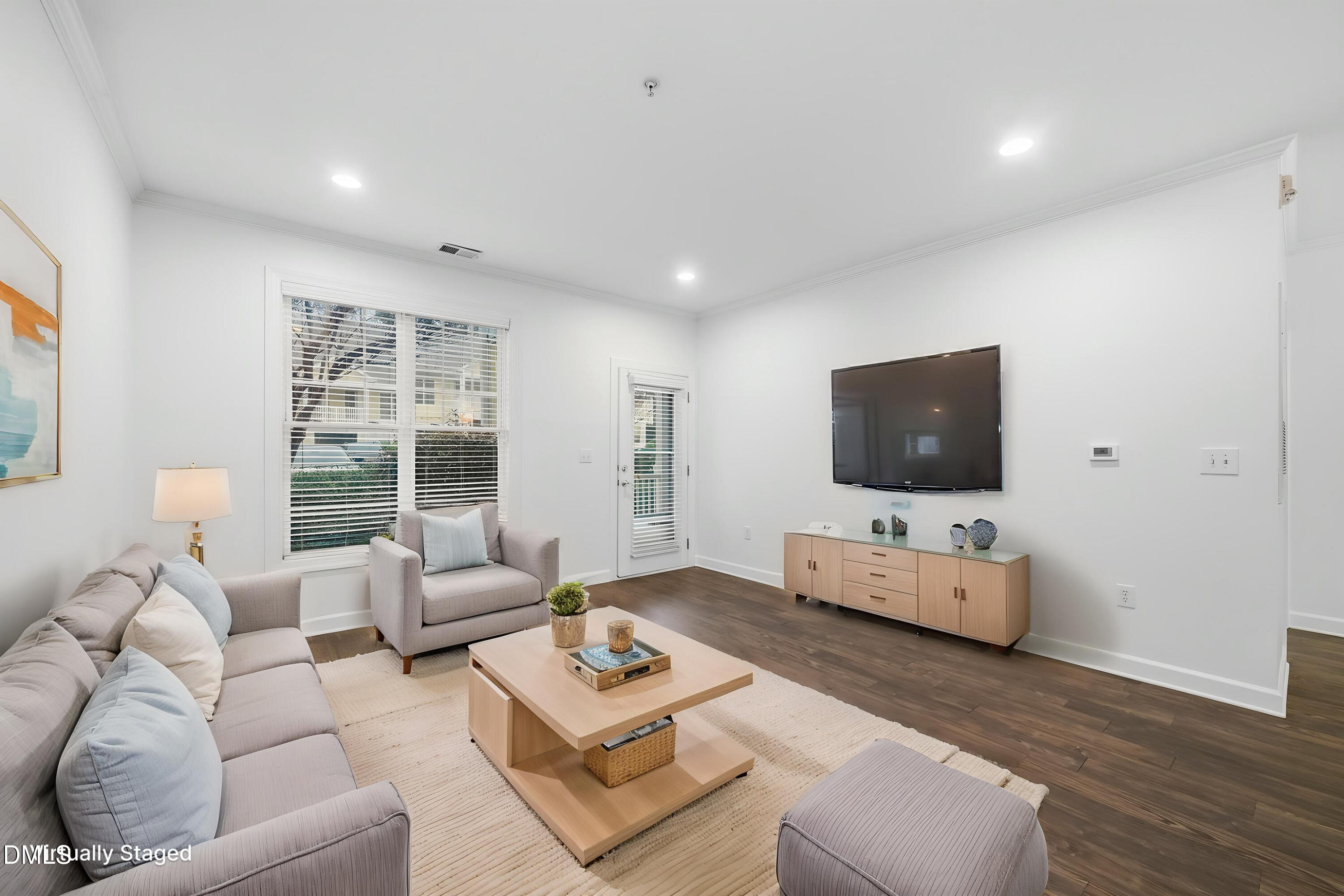 1301 Durlain Drive, Unit 105 Raleigh, NC 27614 - Photo 2 of 27 a living room with furniture and a flat screen tv