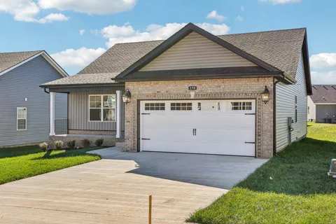 a view of a white house with a yard and large windows