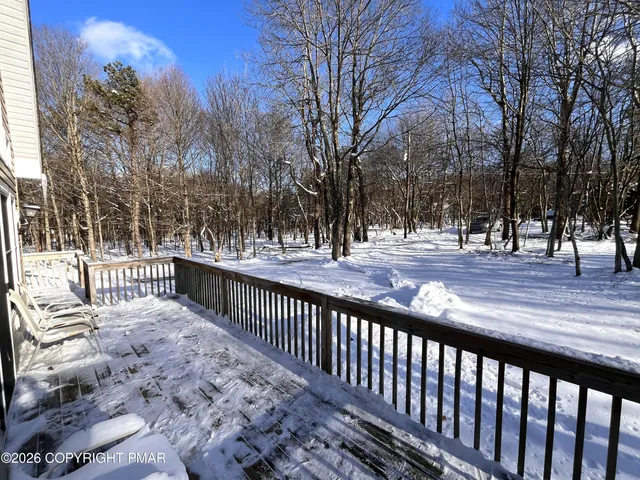 a view of a house with a door and wooden bench