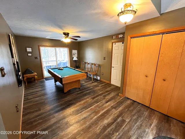 a room with pool table and a chandelier