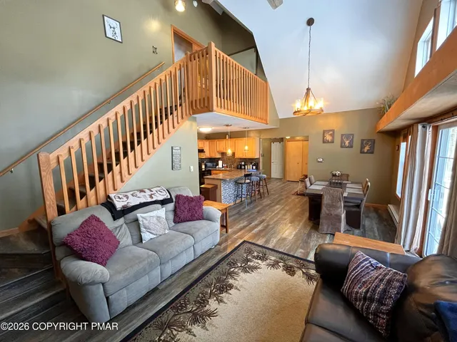 a living room with furniture fireplace and a large window