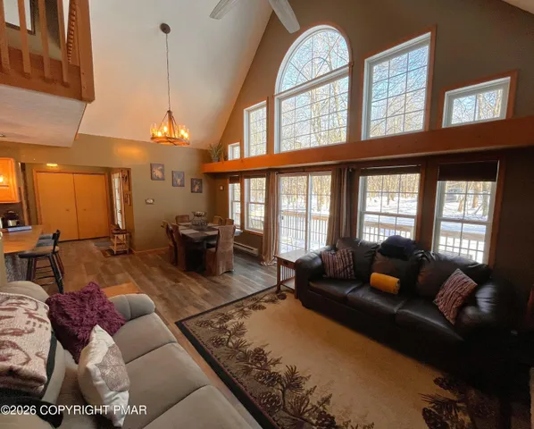 a living room with furniture fireplace and a large window