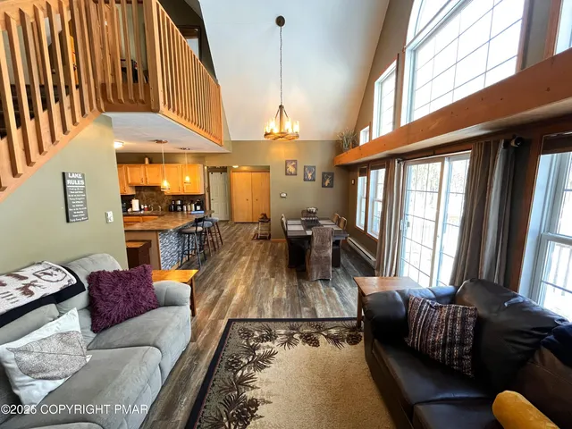 a living room with stainless steel appliances kitchen island granite countertop furniture and a kitchen view