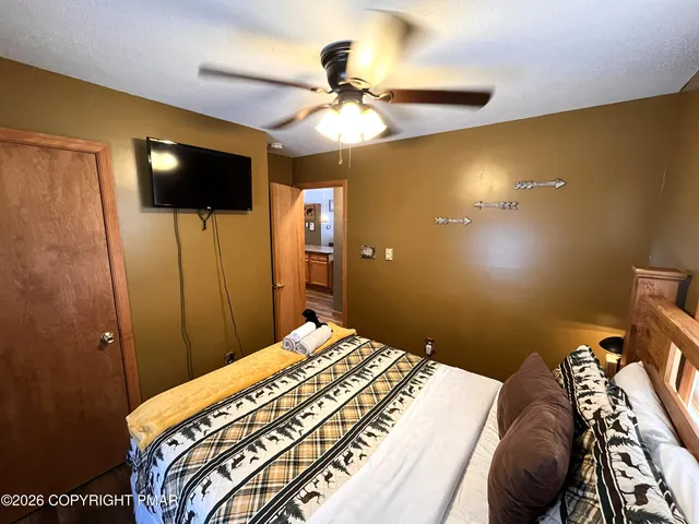 a living room with furniture a rug and a large window