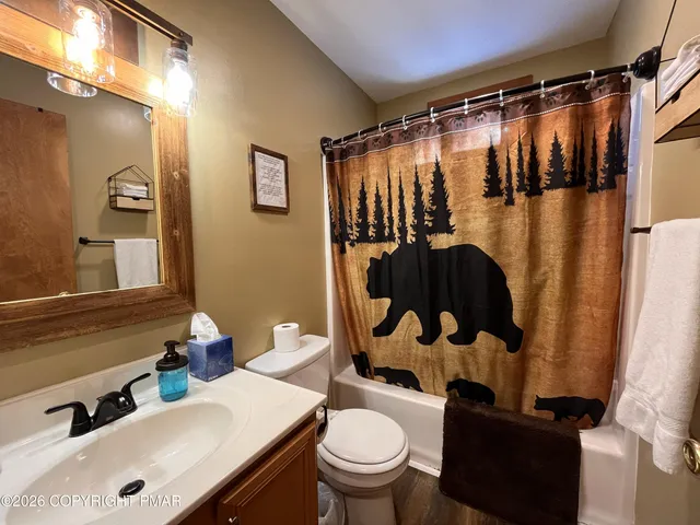 a view of staircase with lots of frames on wall and windows