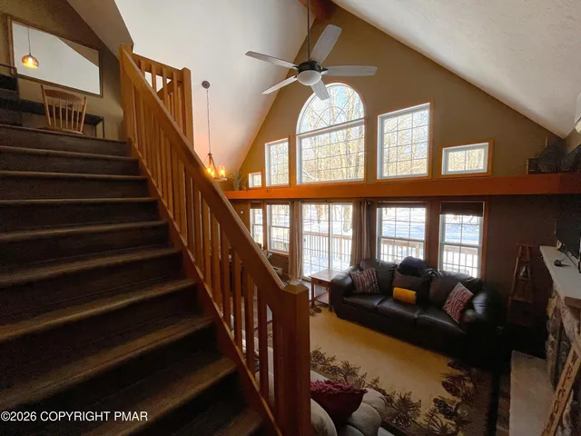 a view of a porch with chairs and backyard