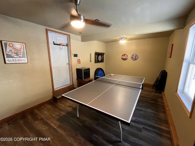 a view of a patio with table and chairs with wooden floor and fence