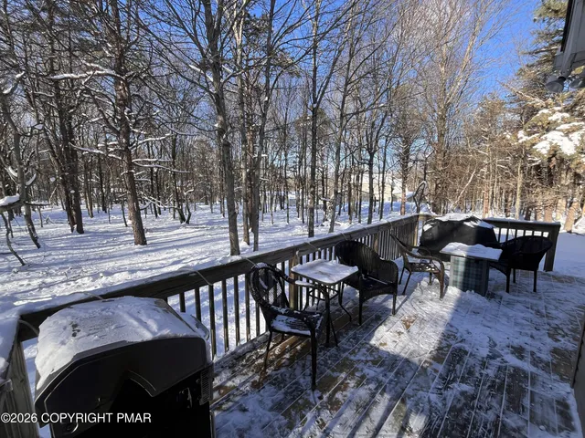 a view of a chairs and table on the deck