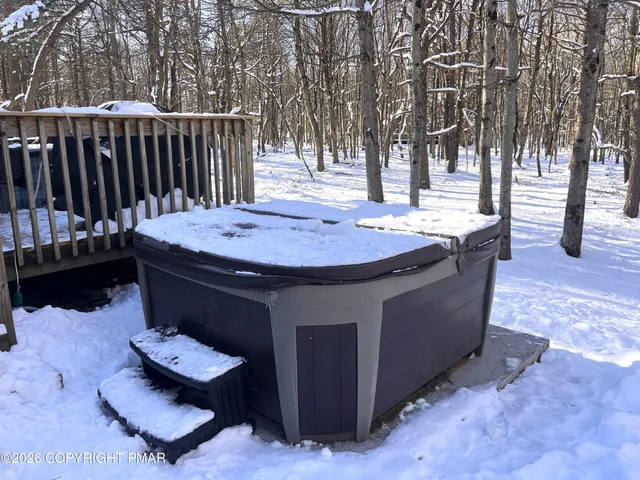 a view of a house with a deck and a yard