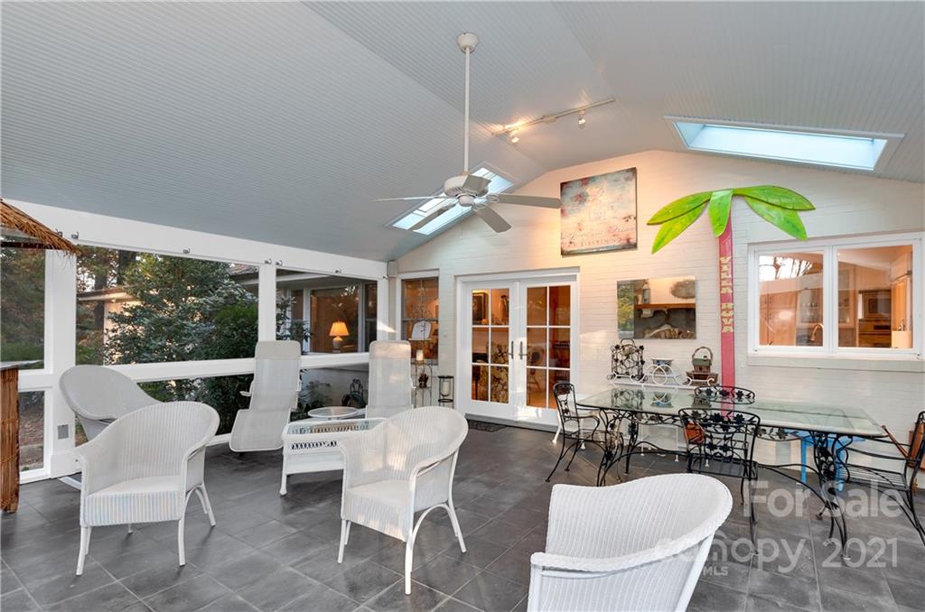 9 Forest Road Biltmore Forest, NC 28803 - Photo 15 of 36 a dining room with furniture a flat screen tv and a large window