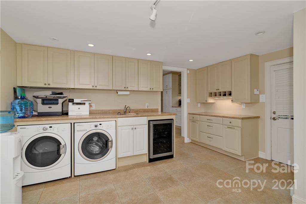 9 Forest Road Biltmore Forest, NC 28803 - Photo 17 of 36 a kitchen with a stove top oven sink and cabinets