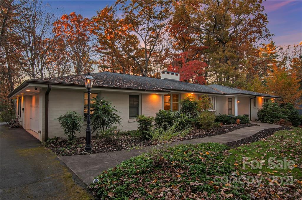 9 Forest Road Biltmore Forest, NC 28803 - Photo 2 of 36 a front view of house with yard and trees around