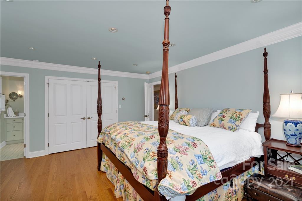 9 Forest Road Biltmore Forest, NC 28803 - Photo 22 of 36 a bedroom with a bed and wooden floor