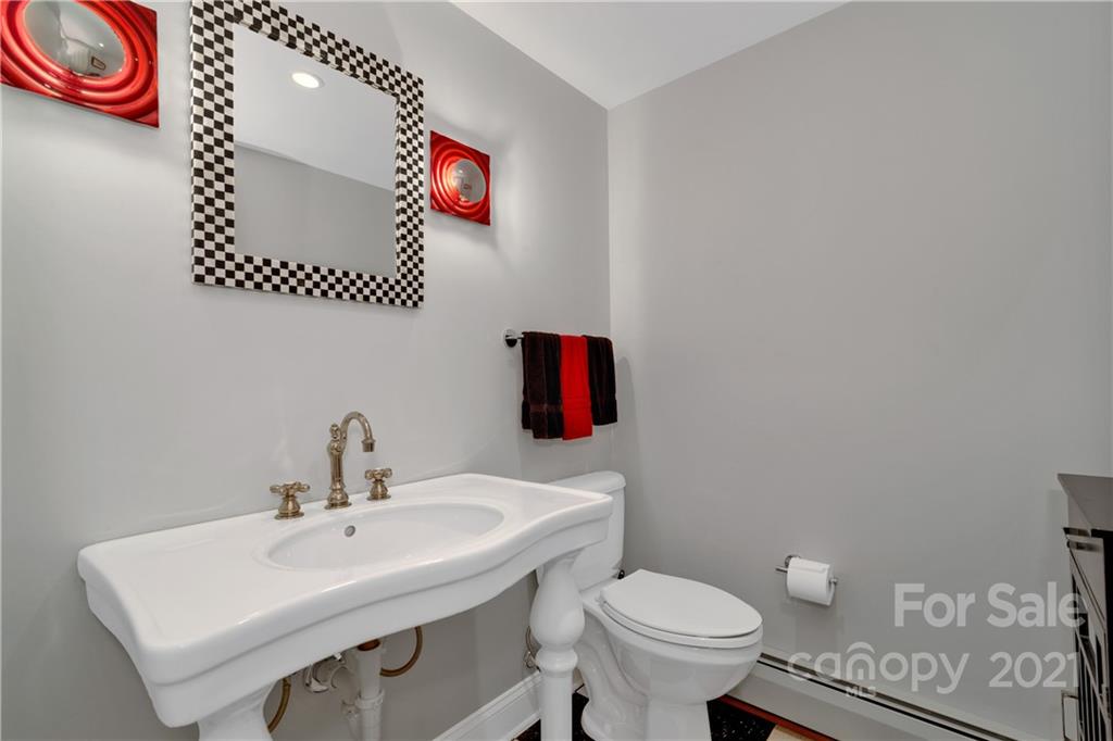 9 Forest Road Biltmore Forest, NC 28803 - Photo 28 of 36 a bathroom with a sink and a toilet