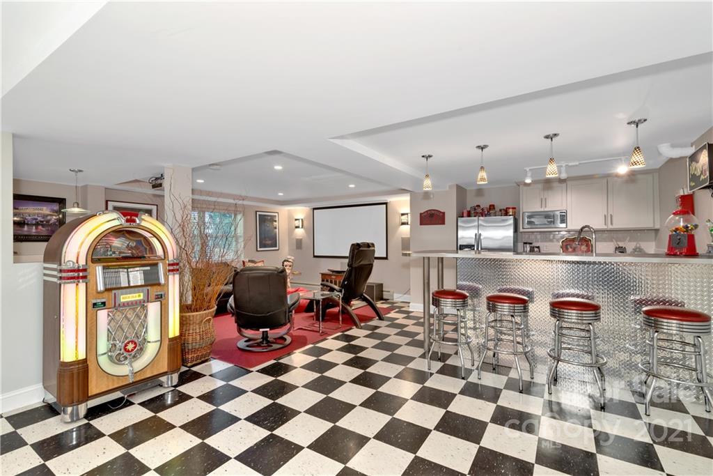 9 Forest Road Biltmore Forest, NC 28803 - Photo 30 of 36 a living room with a gaming machine and dining table