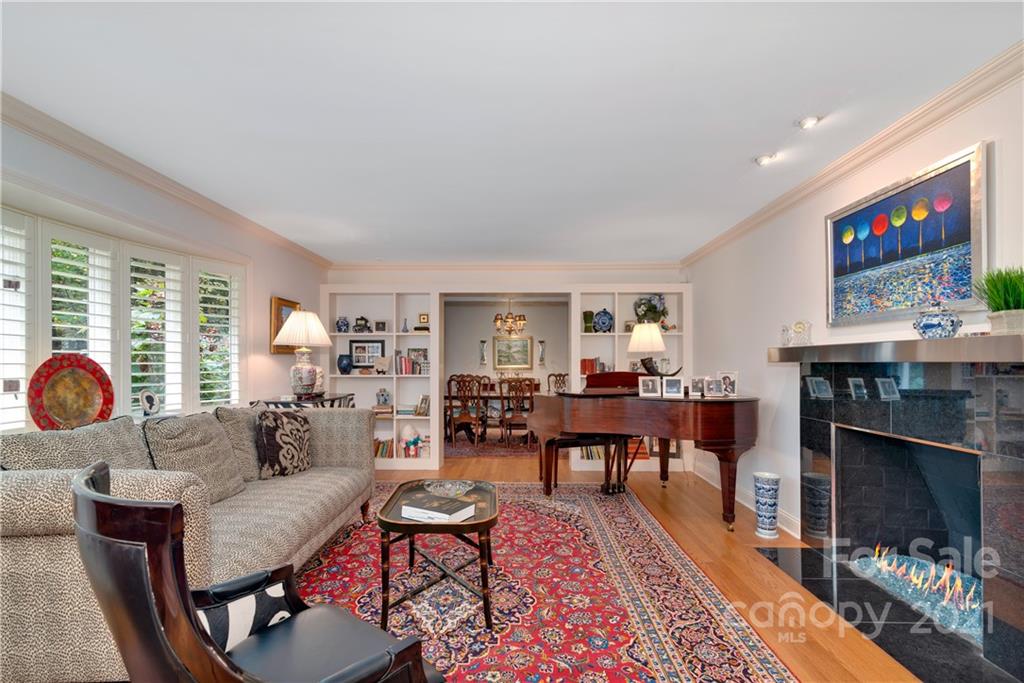 9 Forest Road Biltmore Forest, NC 28803 - Photo 7 of 36 a living room with furniture a rug and a fireplace