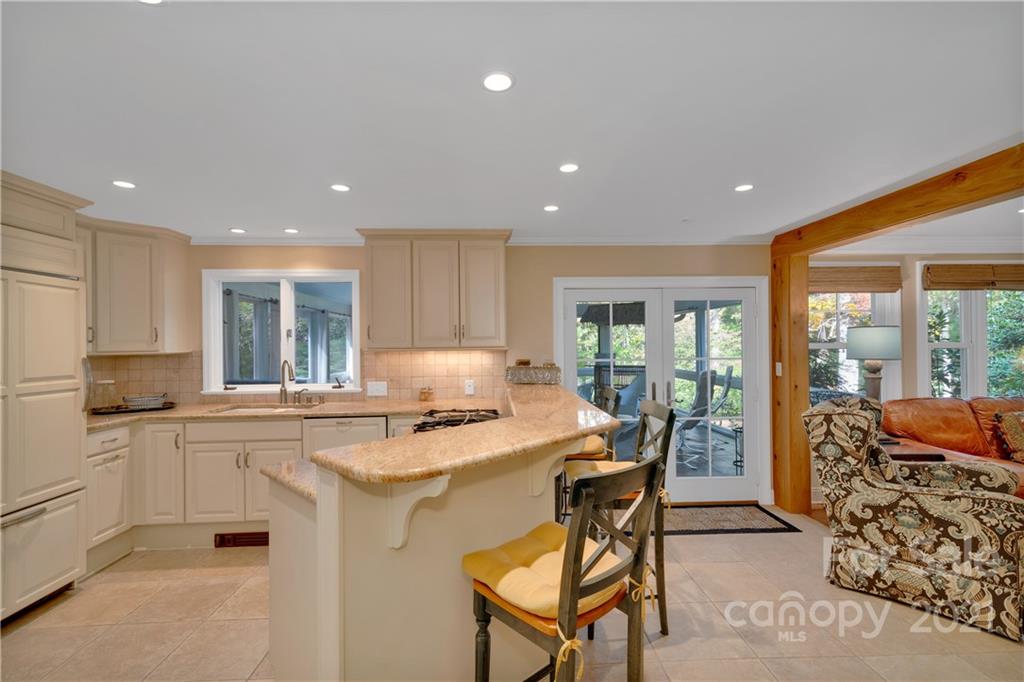 9 Forest Road Biltmore Forest, NC 28803 - Photo 10 of 36 a kitchen with stainless steel appliances granite countertop a stove top oven a sink and a refrigerator