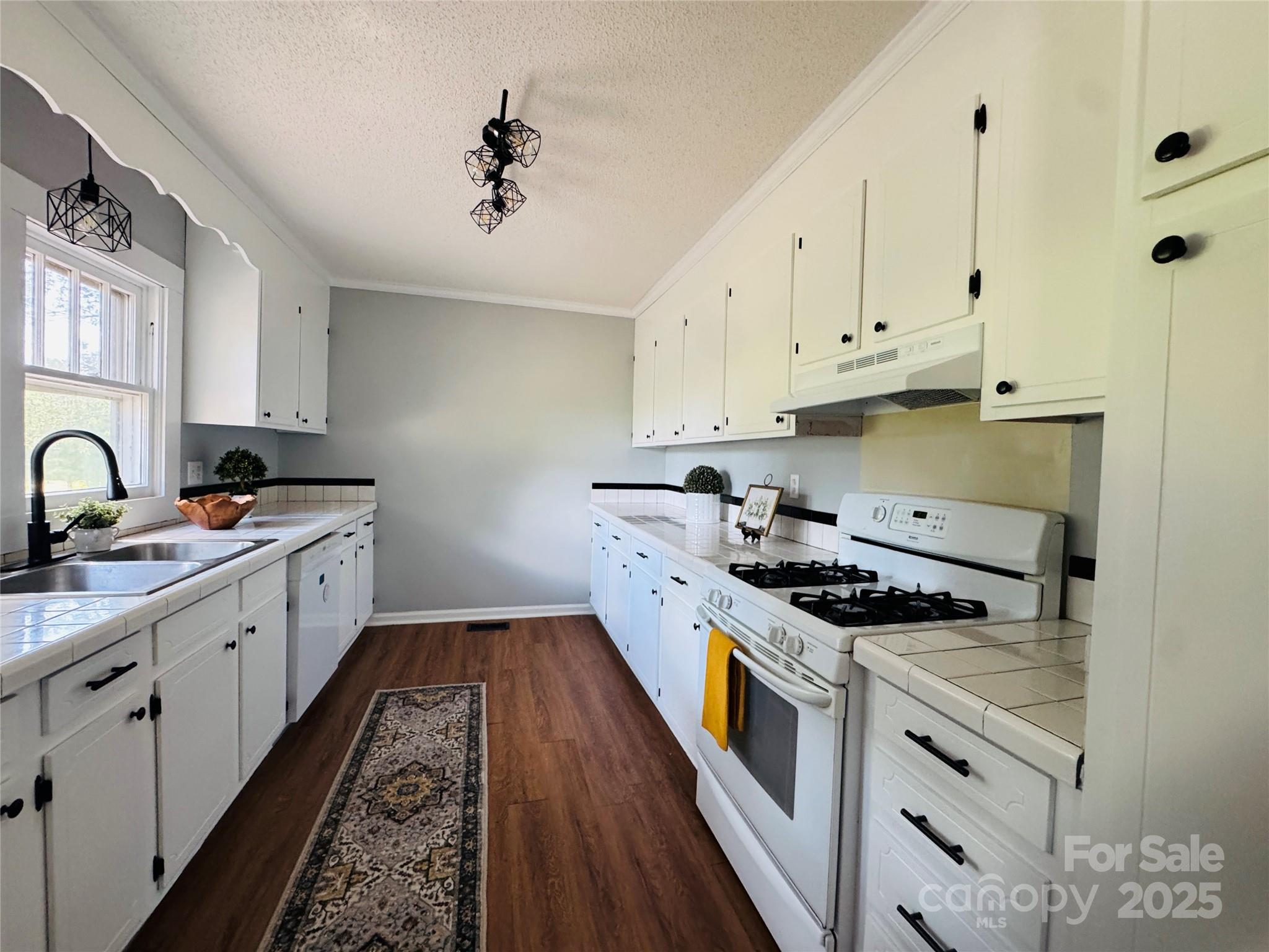 7660 Pop Basinger Road Rockwell, NC 28138 - Photo 5 of 28 a kitchen with granite countertop a sink stove and cabinets