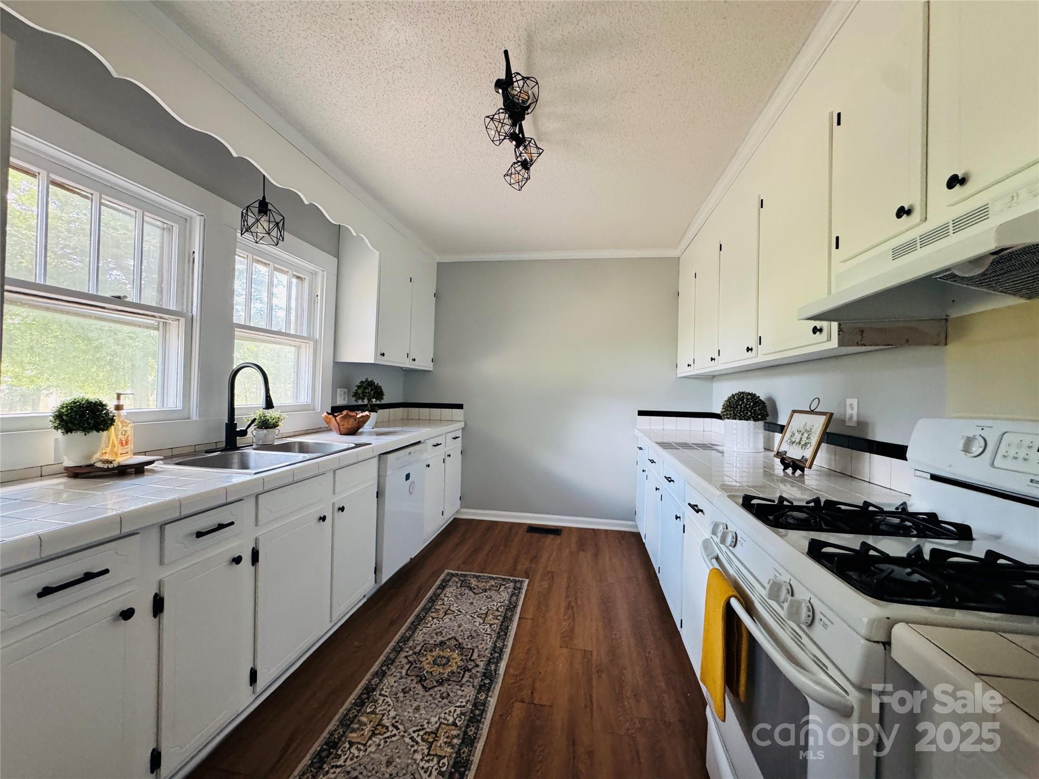 7660 Pop Basinger Road Rockwell, NC 28138 - Photo 6 of 28 a kitchen with sink stove and cabinets