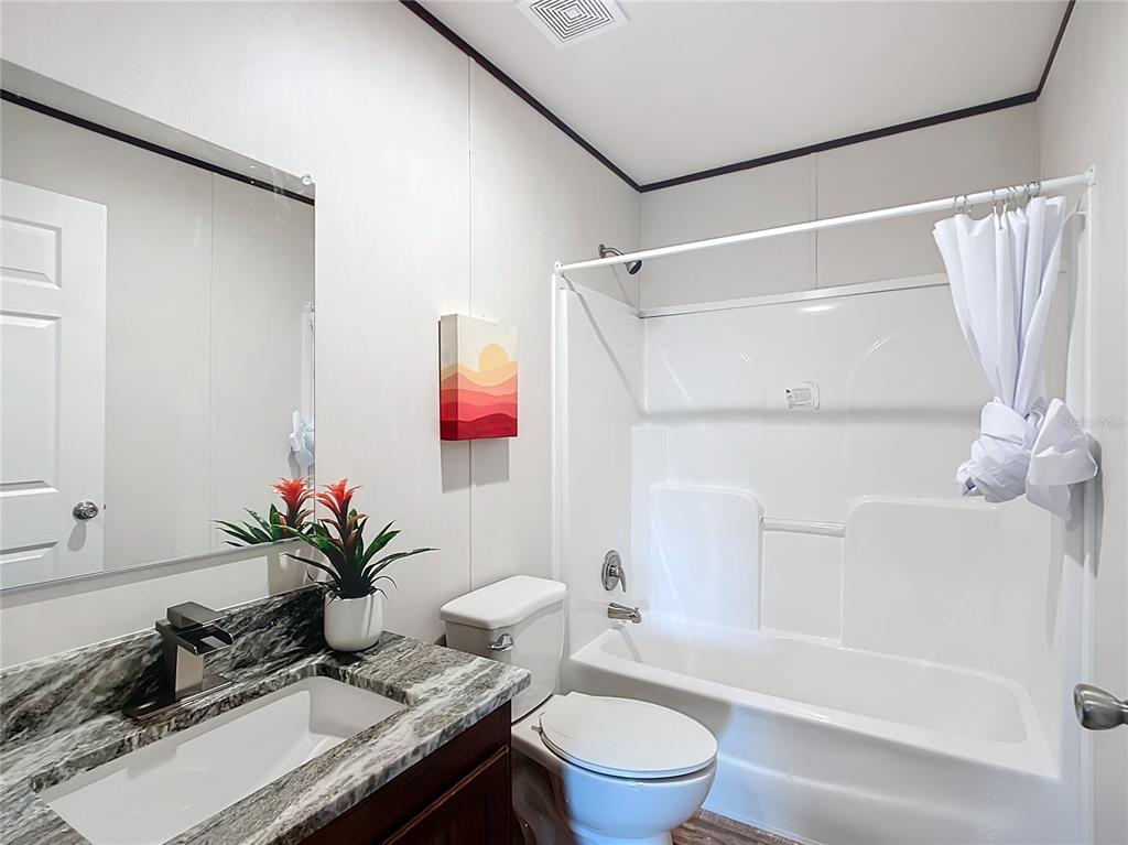 8551 Northwest 125 Street Chiefland, FL 32626 - Photo 24 of 35 a bath room with a toilet and a bath tub