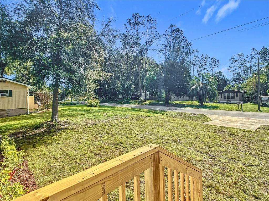 8551 Northwest 125 Street Chiefland, FL 32626 - Photo 5 of 35 a view of a swimming pool with a bench and trees around