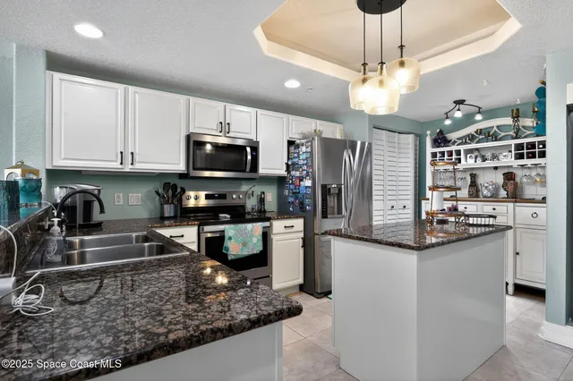 a kitchen with stainless steel appliances granite countertop a sink and cabinets