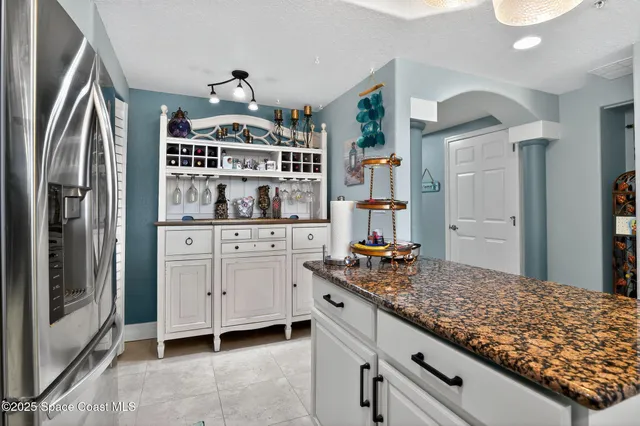 a bedroom with a bed and a flat tv screen on dresser