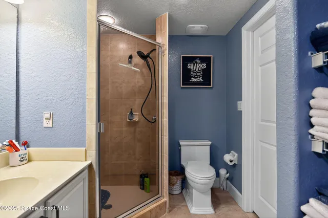 a view of walk in closet with clothes