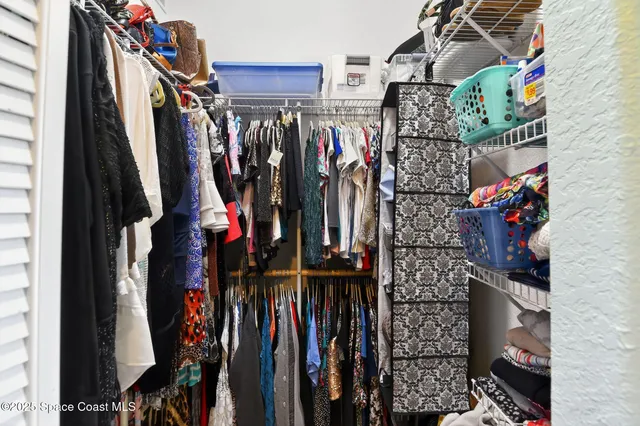 a bedroom with two beds and a chair