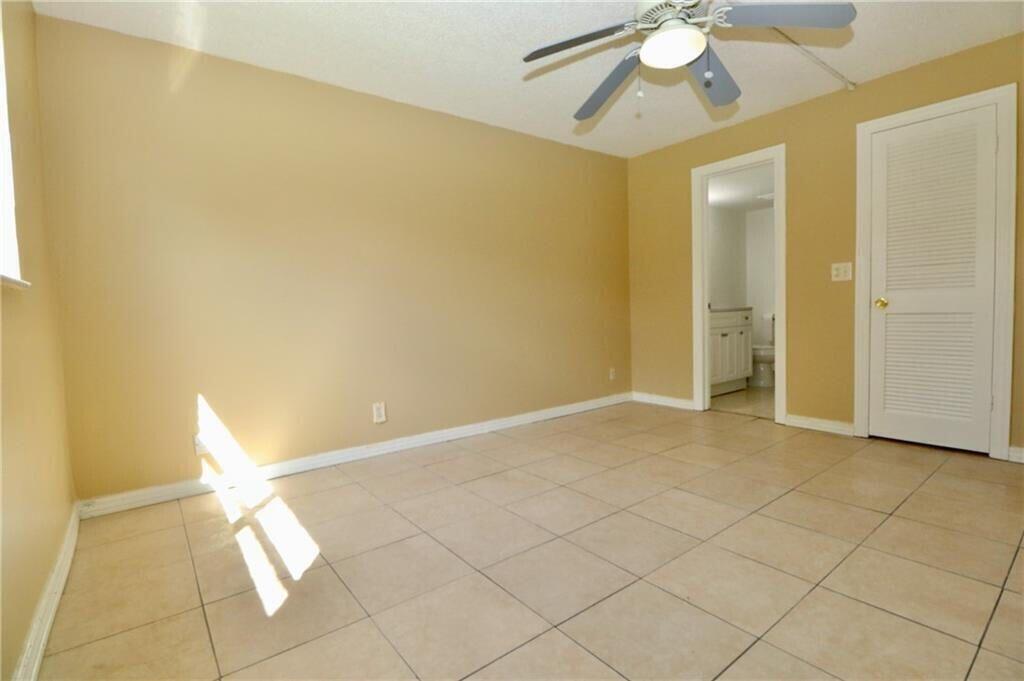 9915 Sandalfoot Boulevard, Unit 408 Boca Raton, FL 33428 - Photo 18 of 19 a view of an empty room and chandelier fan