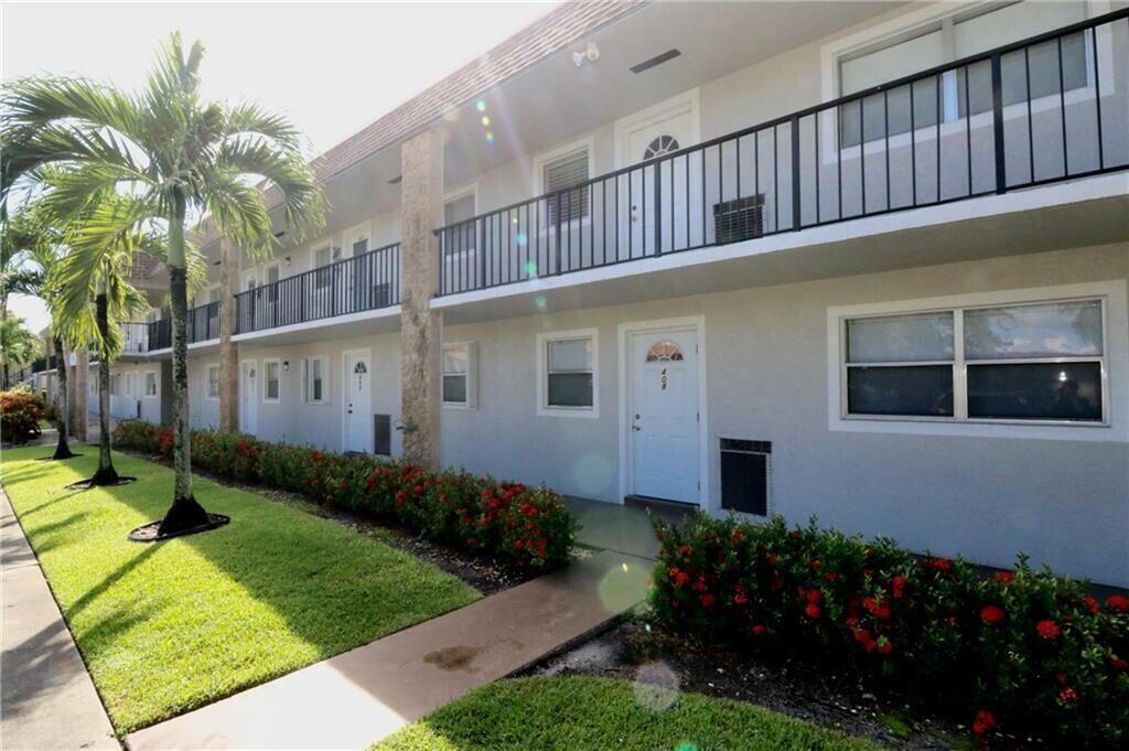 9915 Sandalfoot Boulevard, Unit 408 Boca Raton, FL 33428 - Photo 2 of 19 a view of a house with backyard and garden