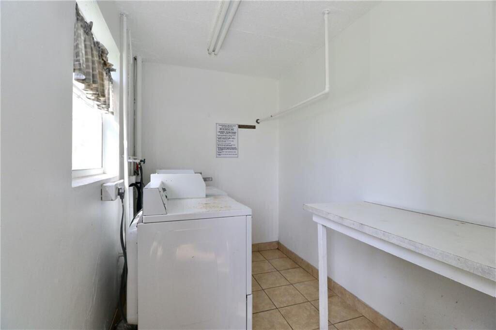 9915 Sandalfoot Boulevard, Unit 408 Boca Raton, FL 33428 - Photo 3 of 19 a utility room with dryer and washer