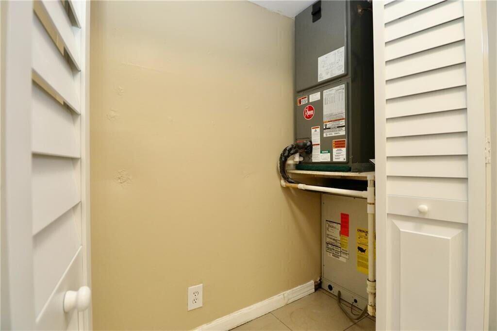 9915 Sandalfoot Boulevard, Unit 408 Boca Raton, FL 33428 - Photo 10 of 19 a utility room with dryer and washer