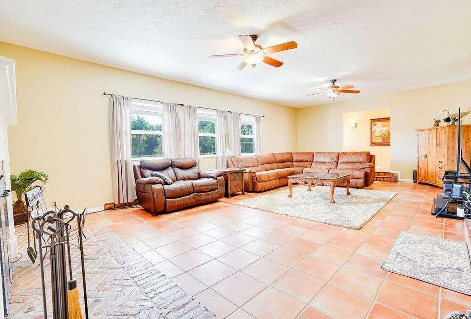 7600 Immokolee Road Fort Pierce, FL 34951 - Photo 11 of 32 a living room with furniture fireplace and a large window