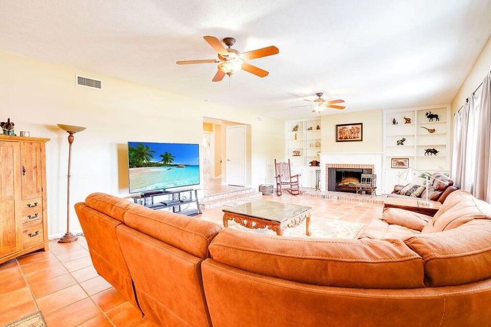 7600 Immokolee Road Fort Pierce, FL 34951 - Photo 12 of 32 a living room with furniture and a fireplace