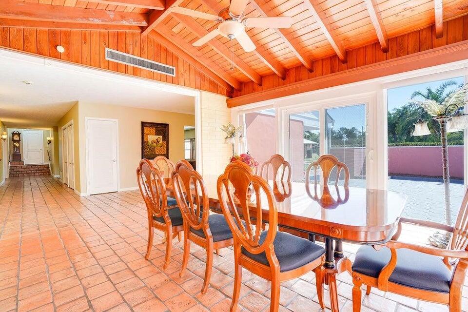 7600 Immokolee Road Fort Pierce, FL 34951 - Photo 15 of 32 a dining room with furniture and wooden floor