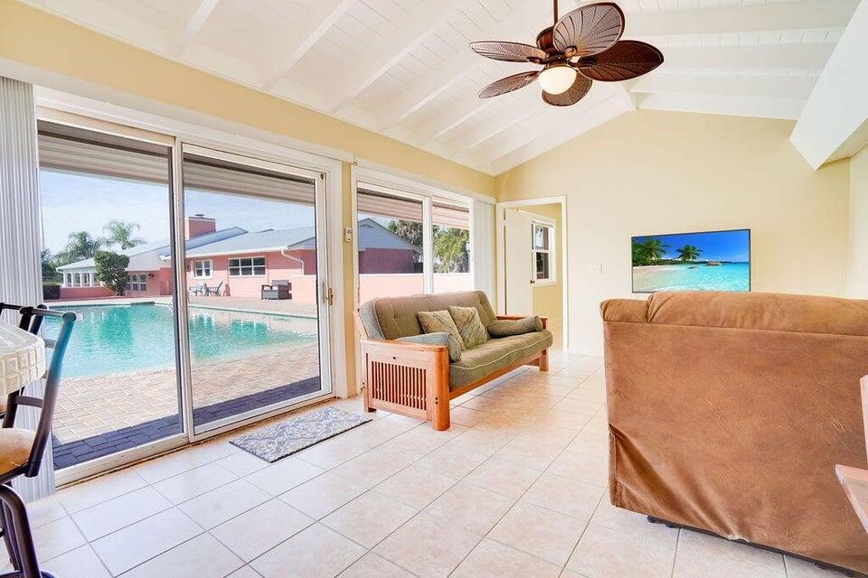 7600 Immokolee Road Fort Pierce, FL 34951 - Photo 25 of 32 a living room with furniture and a floor to ceiling window