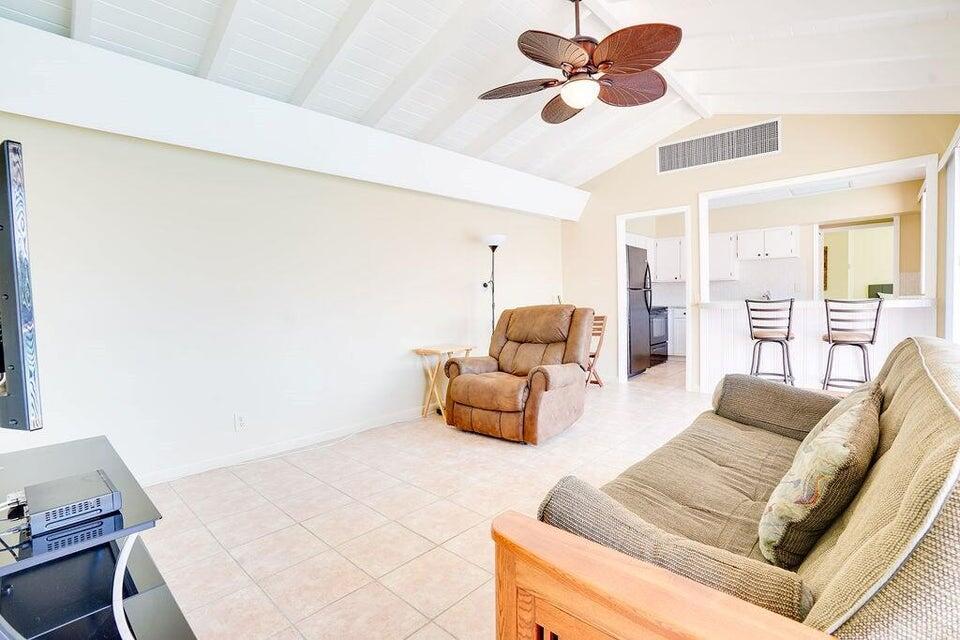 7600 Immokolee Road Fort Pierce, FL 34951 - Photo 26 of 32 a living room with furniture and a chandelier