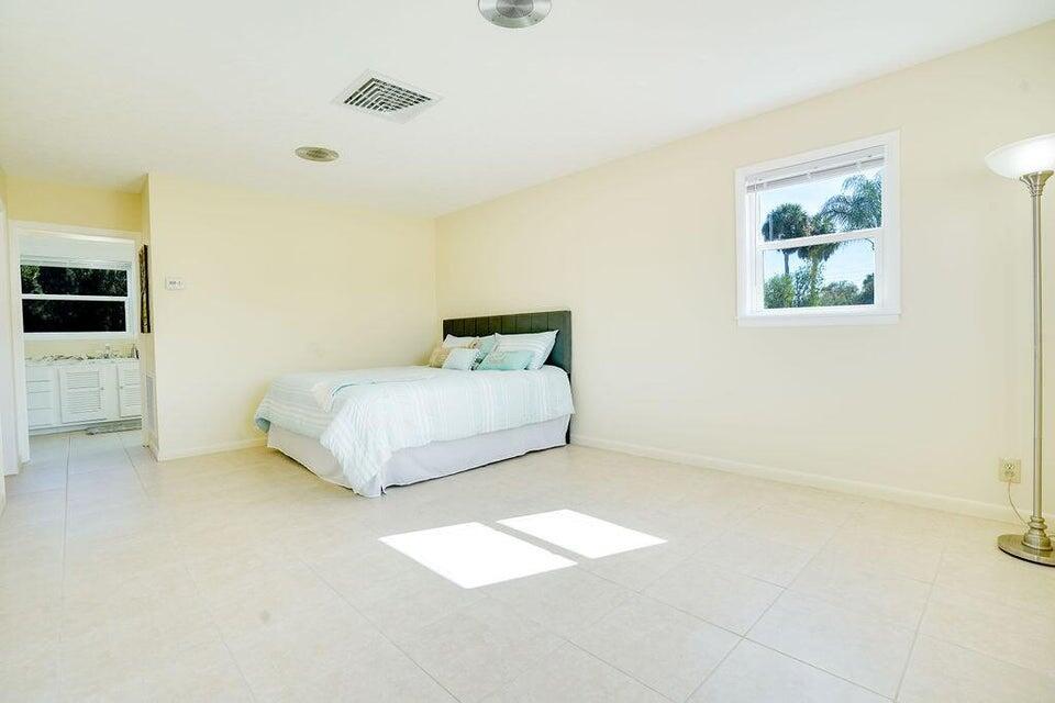7600 Immokolee Road Fort Pierce, FL 34951 - Photo 28 of 32 a bedroom with a bed and table