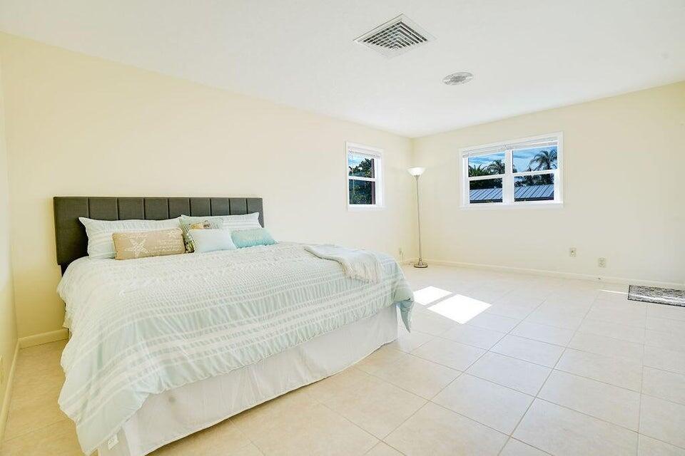 7600 Immokolee Road Fort Pierce, FL 34951 - Photo 29 of 32 a bedroom with a bed and a night stand