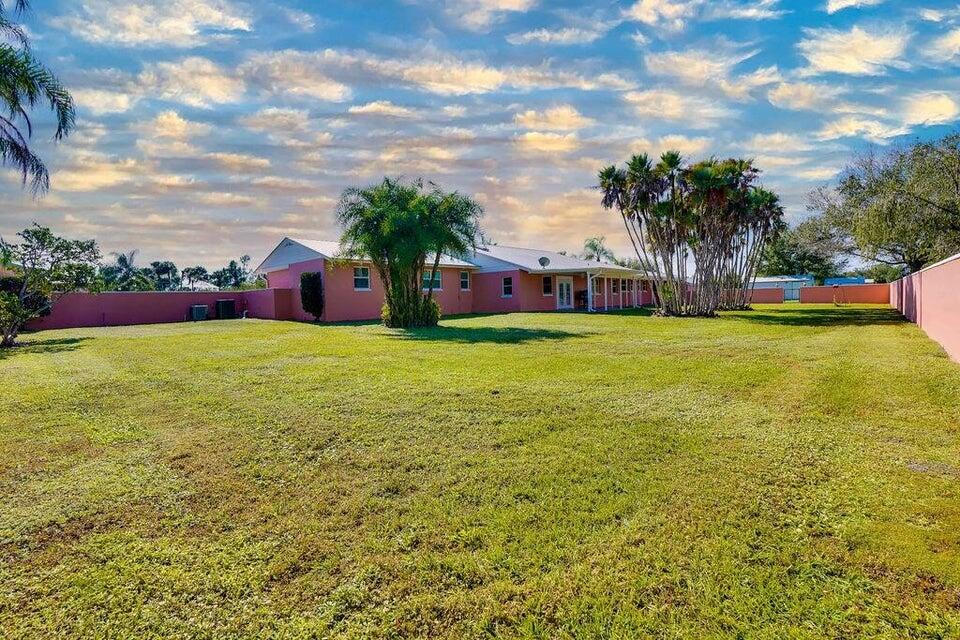 7600 Immokolee Road Fort Pierce, FL 34951 - Photo 7 of 32 a view of a swimming pool with an outdoor seating and a yard