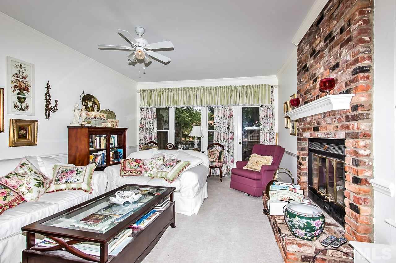 7619 Trowbridge Court Raleigh, NC 27613 - Photo 12 of 25 a living room with furniture and a fireplace