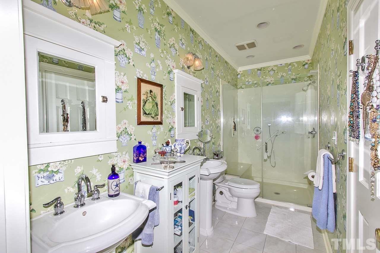 7619 Trowbridge Court Raleigh, NC 27613 - Photo 15 of 25 a bathroom with a sink toilet mirror and shower