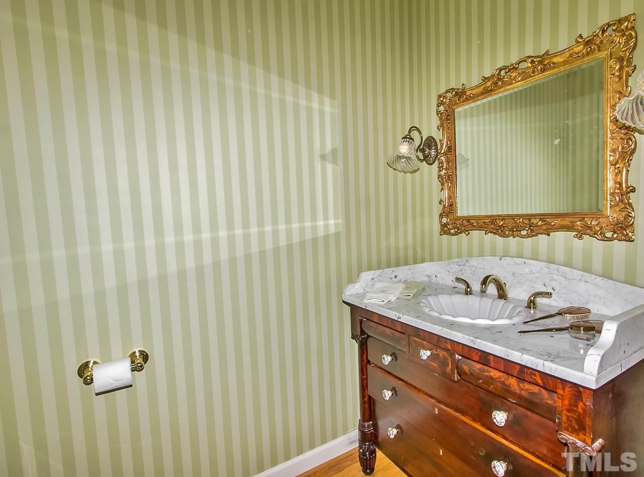 7619 Trowbridge Court Raleigh, NC 27613 - Photo 16 of 25 a bathroom with a sink and a mirror