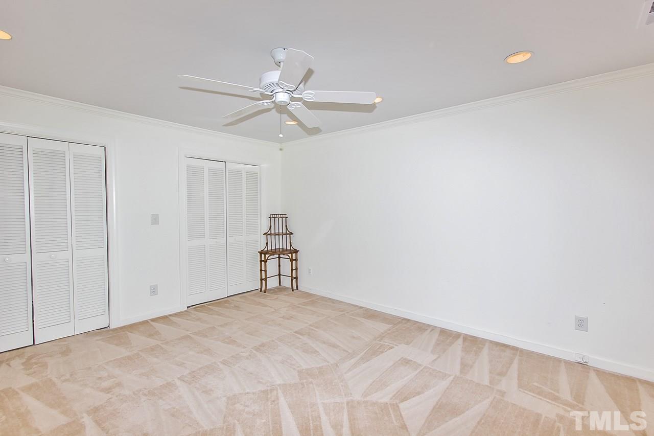 7619 Trowbridge Court Raleigh, NC 27613 - Photo 18 of 25 a view of empty room with window and ceiling fan