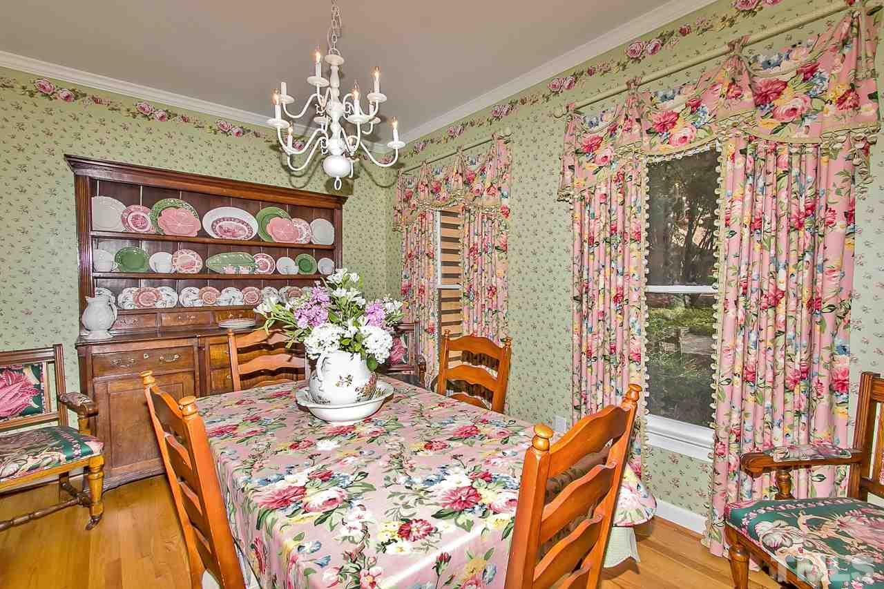 7619 Trowbridge Court Raleigh, NC 27613 - Photo 4 of 25 a dining room with furniture and chandelier kitchen view