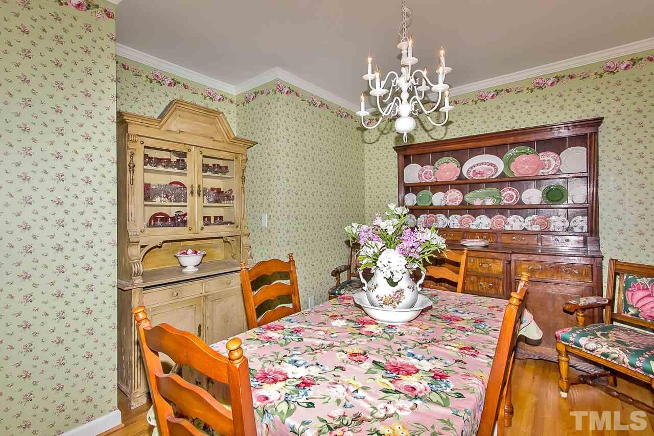 7619 Trowbridge Court Raleigh, NC 27613 - Photo 5 of 25 a dining room filled with furniture and chandelier