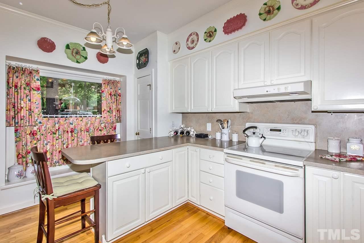 7619 Trowbridge Court Raleigh, NC 27613 - Photo 6 of 25 a kitchen with a sink stove and microwave