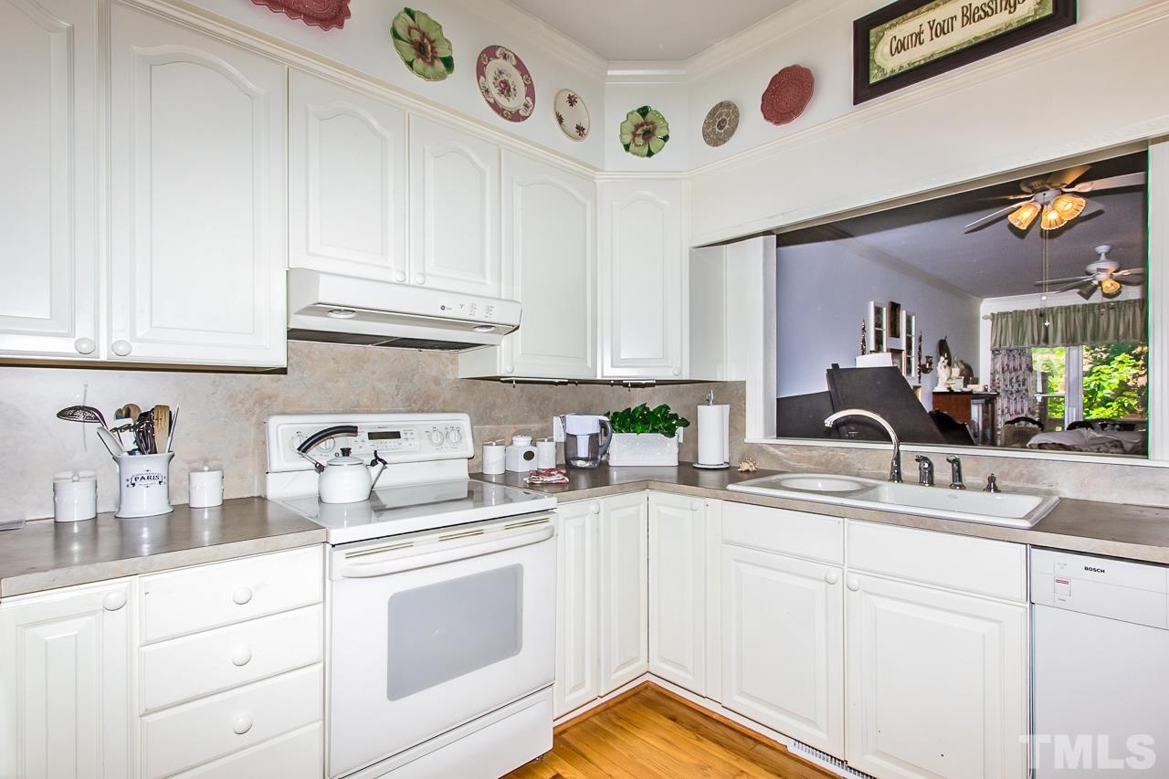 7619 Trowbridge Court Raleigh, NC 27613 - Photo 7 of 25 a kitchen with cabinets appliances and a counter top