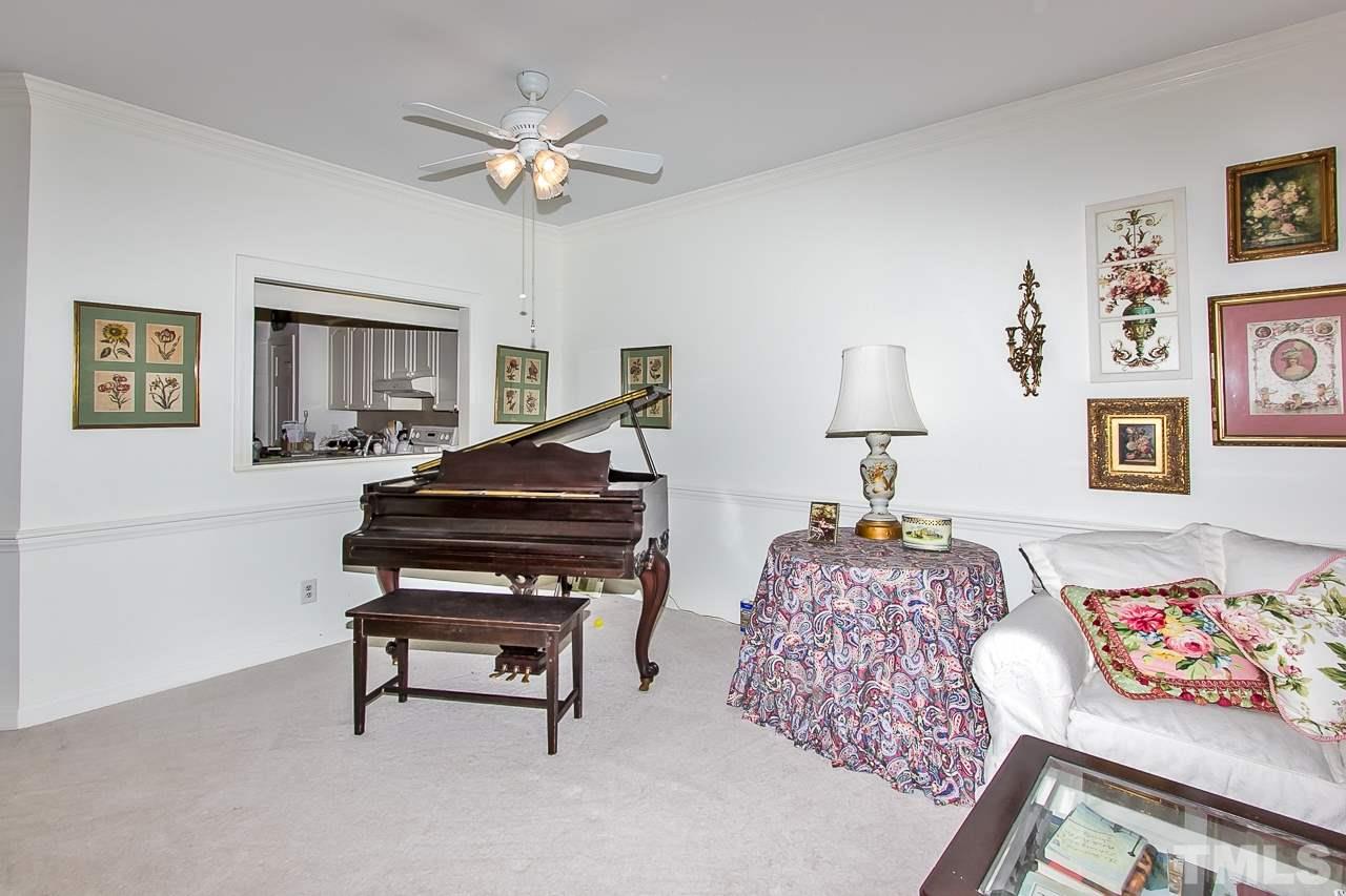 7619 Trowbridge Court Raleigh, NC 27613 - Photo 9 of 25 a living room with furniture and a piano